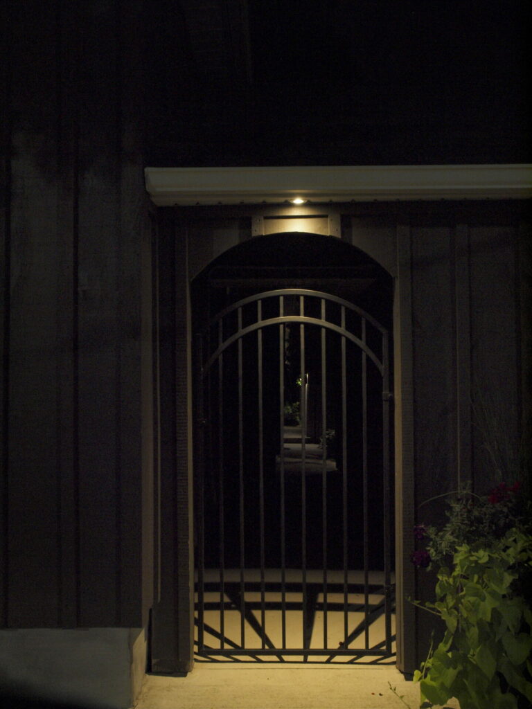 A black gate with a light on it.