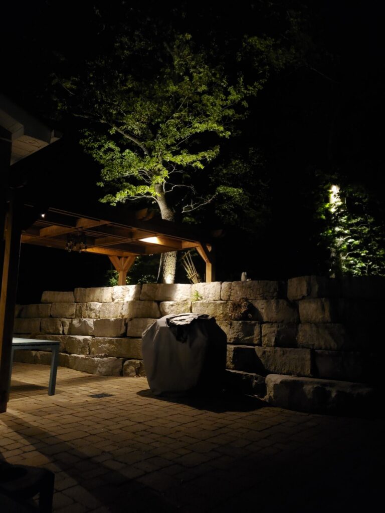 A stone patio lit up at night.