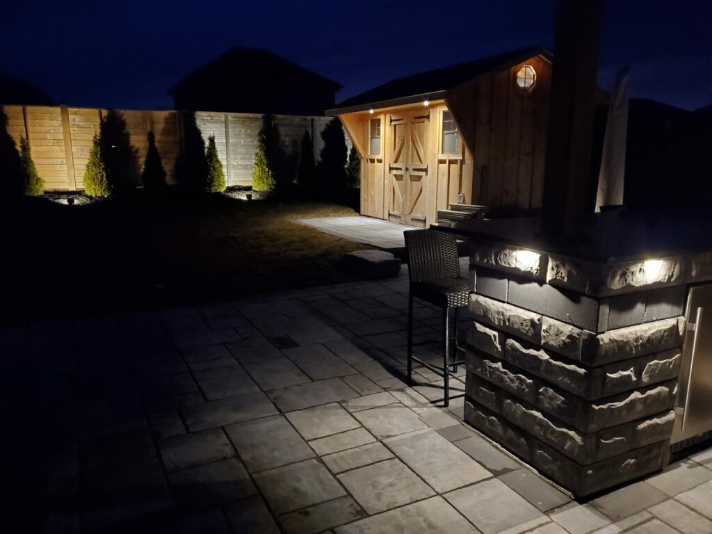 A patio with outdoor lighting at night.