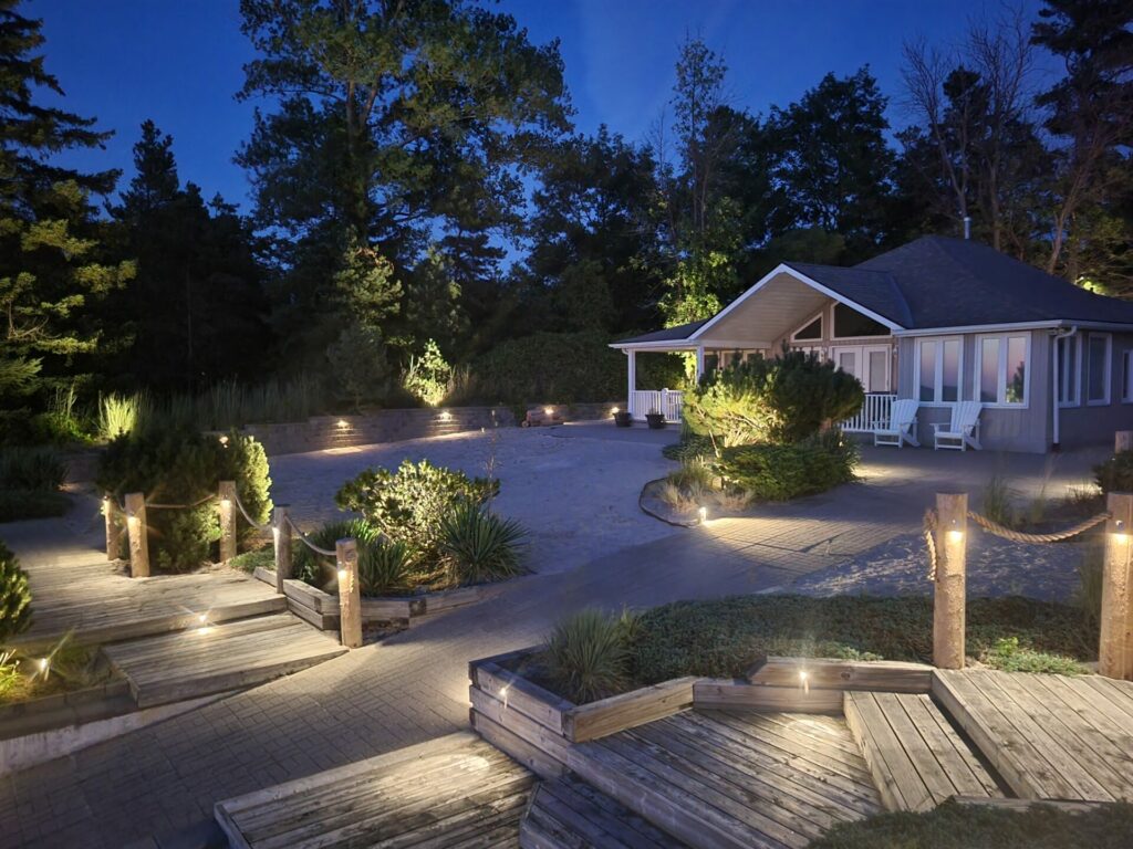A backyard with outdoor lighting at night.
