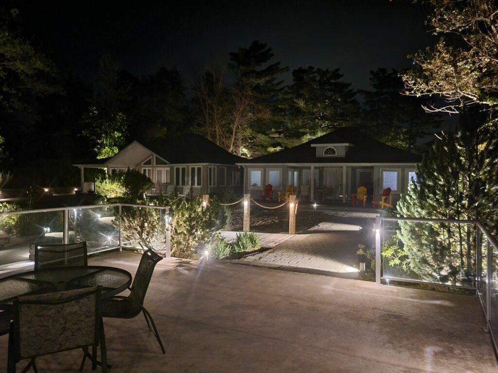A patio with outdoor lighting at night.