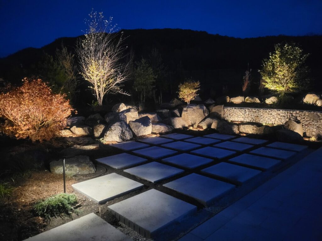 A stone walkway lit up at night.