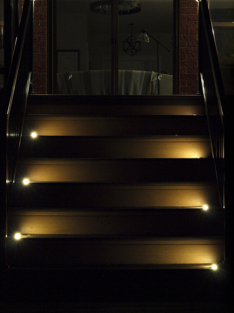 A set of stairs lit up at night.