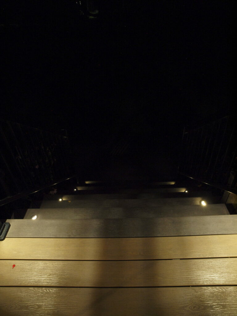 A wooden stairway in the dark.
