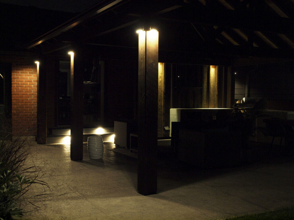An outdoor living space with outdoor lightning at night.