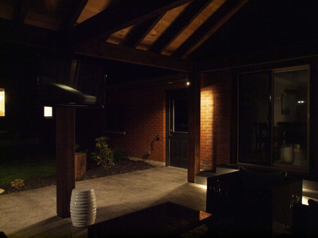 A patio with lights at night.