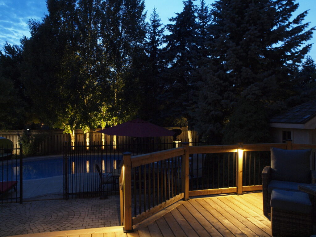 A deck with outdoor lighting at night.